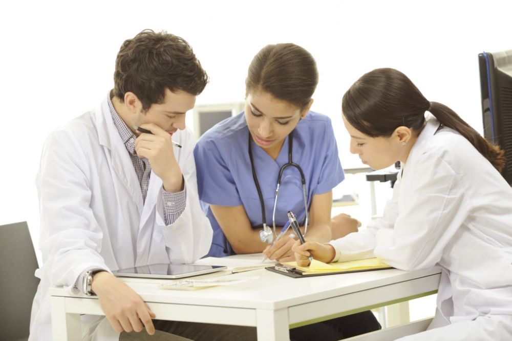 Healthcare professionals reviewing documents together