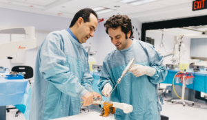 2 individuals at surgical skills stations