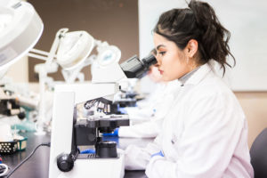 Medical Laboratory Science student at microscope