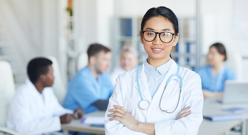 asian doctor standing with arms crossed