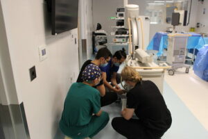 Radiological Technology students and their instructor setting up the C-arm X-ray machine