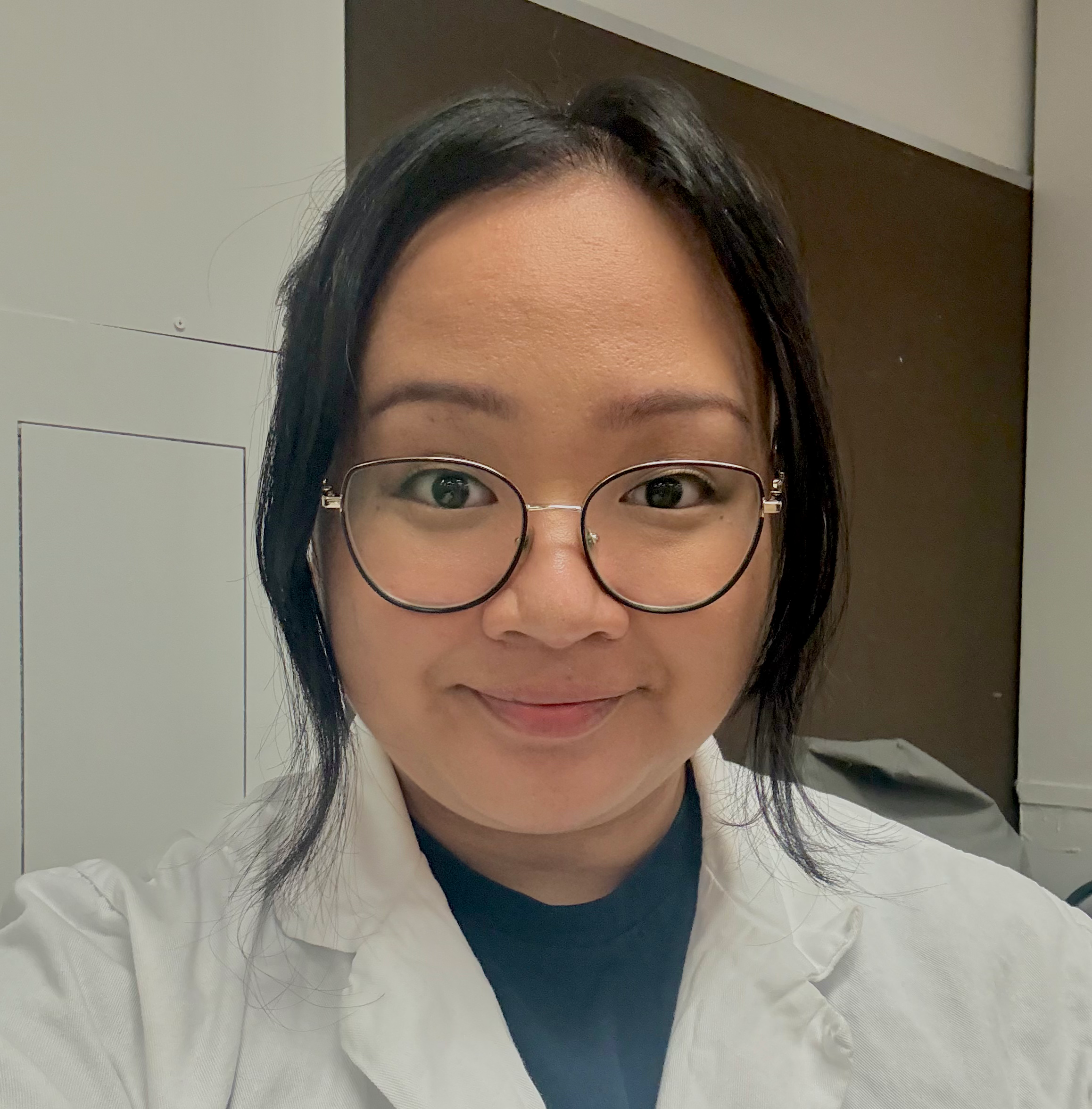 Michener medical laboratory science student Ren Manalo in a lab coat