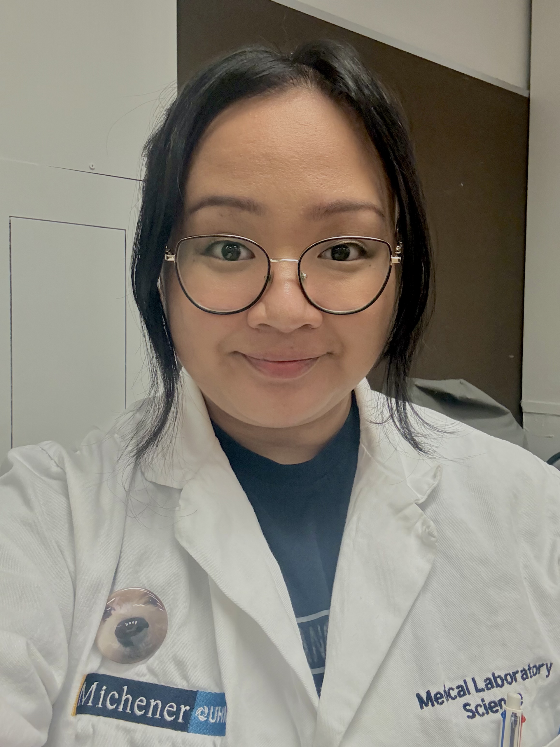 Michener medical laboratory science student Ren Manalo in a lab coat